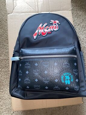 MCM Black Backpack with Red Script Logo and Teal Patch